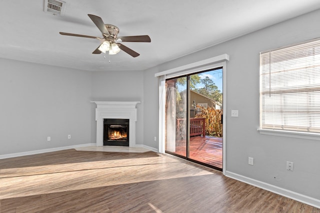 unfurnished living room with hardwood / wood-style floors and ceiling fan