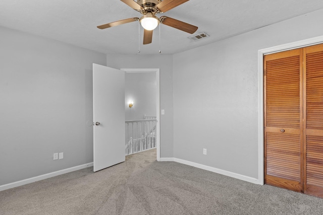 unfurnished bedroom featuring a closet, ceiling fan, and carpet floors