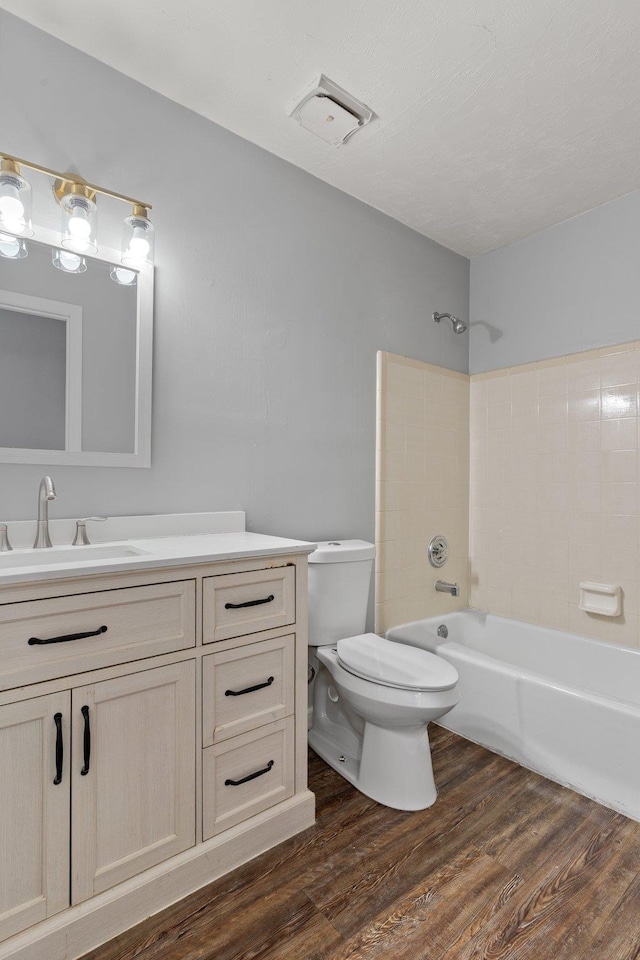 full bathroom with shower / bathing tub combination, vanity, toilet, and hardwood / wood-style flooring