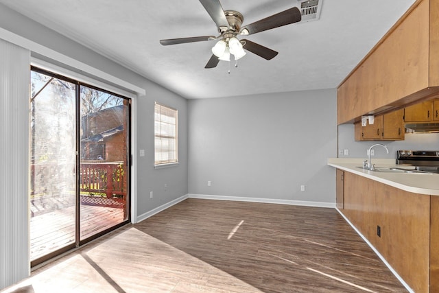 kitchen featuring sink, ceiling fan, stainless steel range with electric cooktop, and dark wood-type flooring