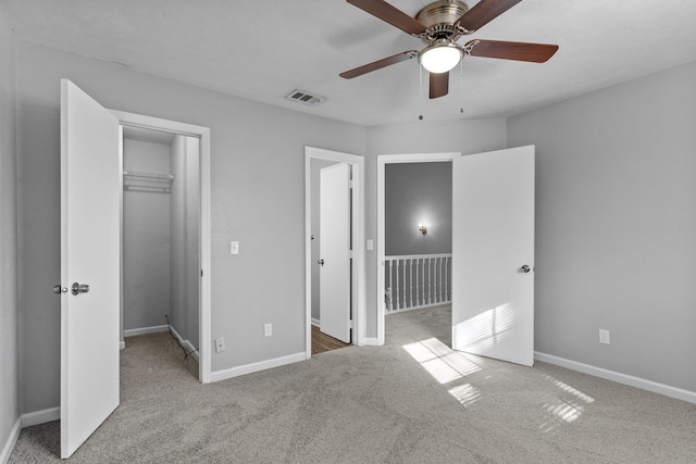 unfurnished bedroom featuring ceiling fan, a closet, and carpet flooring