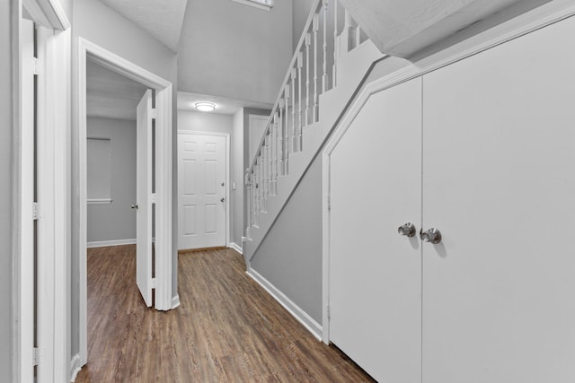 corridor featuring dark wood-type flooring