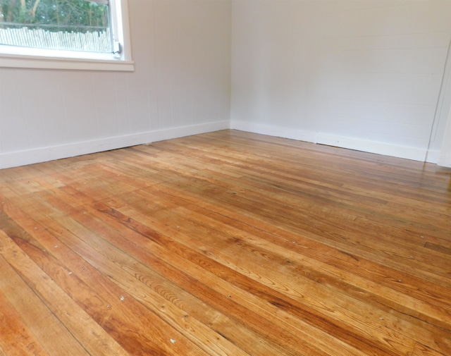 unfurnished room with wood-type flooring