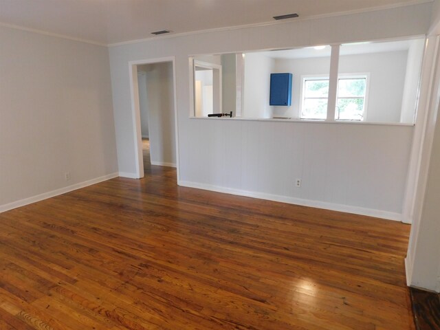 unfurnished room with dark hardwood / wood-style flooring and ornamental molding