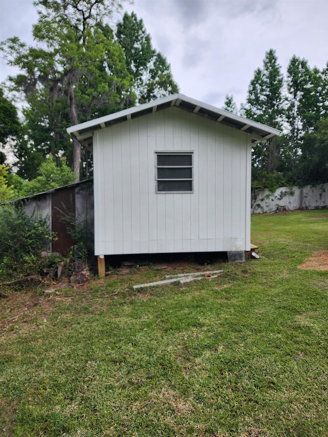 view of outbuilding featuring a lawn