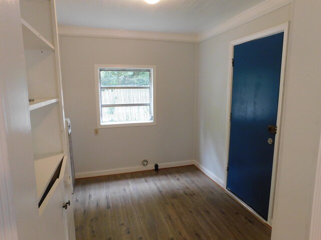 spare room with dark hardwood / wood-style floors and crown molding