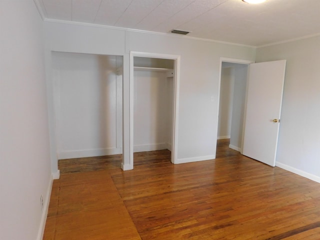 118 N Virginia St, Quincy, FL 32351 - unfurnished bedroom with crown molding, wood finished floors, a closet, and baseboards