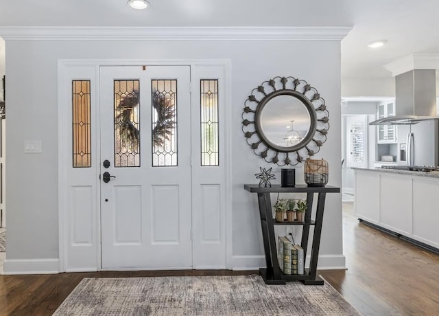 foyer entrance with baseboards, recessed lighting, wood finished floors, and crown molding