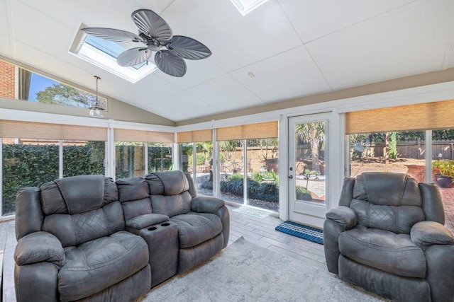 sunroom / solarium featuring a wealth of natural light, lofted ceiling with skylight, and a ceiling fan