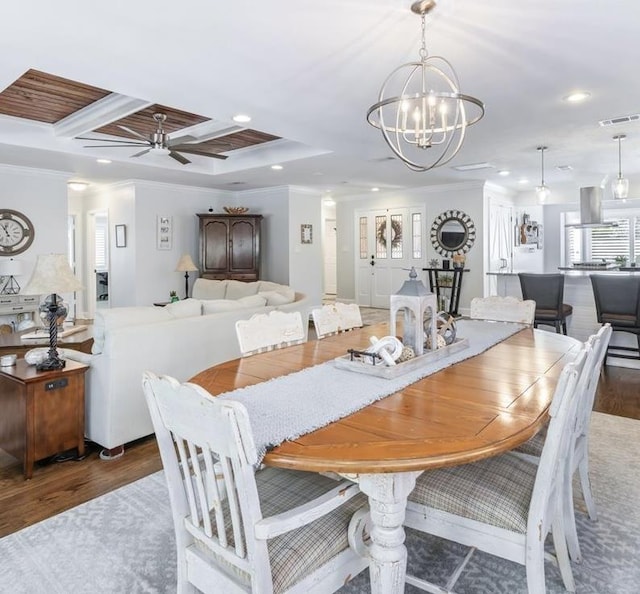 dining space with recessed lighting, wood finished floors, visible vents, and crown molding