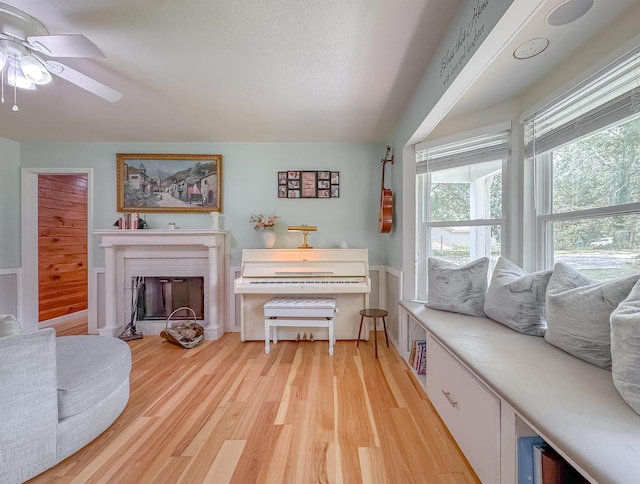 7420 Hickock Ct, Tallahassee, FL 32311 - living area with light wood-style flooring, a ceiling fan, and a fireplace