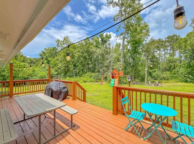7420 Hickock Ct, Tallahassee, FL 32311 - wooden terrace featuring a lawn, a playground, and view of wooded area