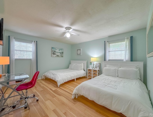 7420 Hickock Ct, Tallahassee, FL 32311 - bedroom featuring multiple windows, wood finished floors, a textured ceiling, and a ceiling fan