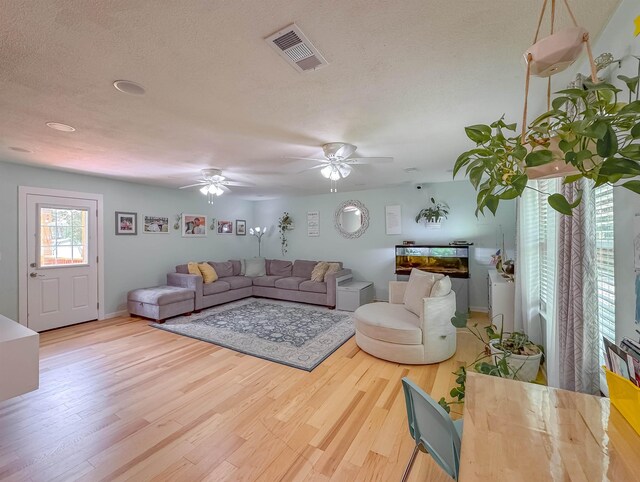 7420 Hickock Ct, Tallahassee, FL 32311 - living area with wood finished floors, ceiling fan, and a textured ceiling