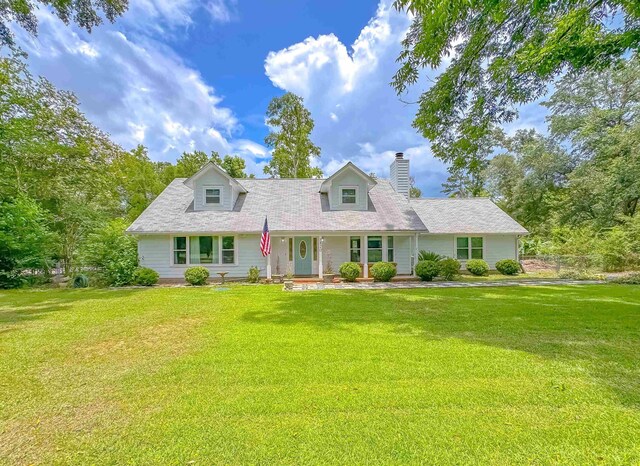 7420 Hickock Ct, Tallahassee, FL 32311 - cape cod home with a front lawn, a chimney, and covered porch