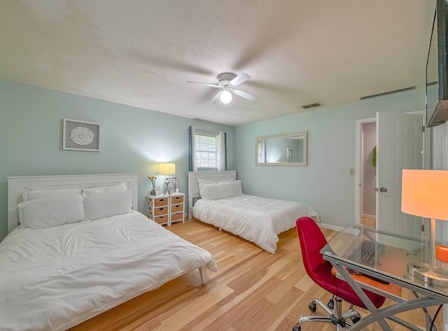 7420 Hickock Ct, Tallahassee, FL 32311 - bedroom with wood finished floors, a textured ceiling, and a ceiling fan