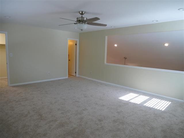 carpeted empty room with ceiling fan