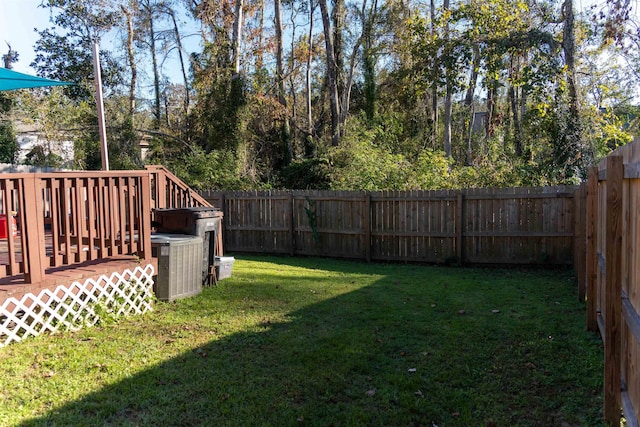 view of yard with central AC and a wooden deck