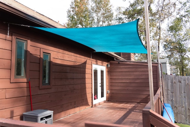 view of side of property featuring a wooden deck and french doors