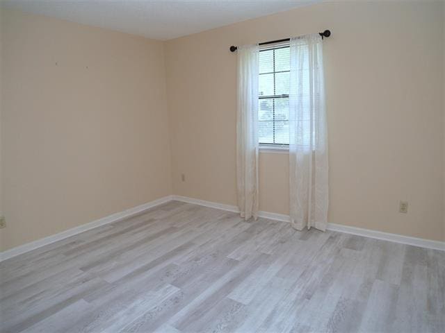 spare room featuring light wood-type flooring