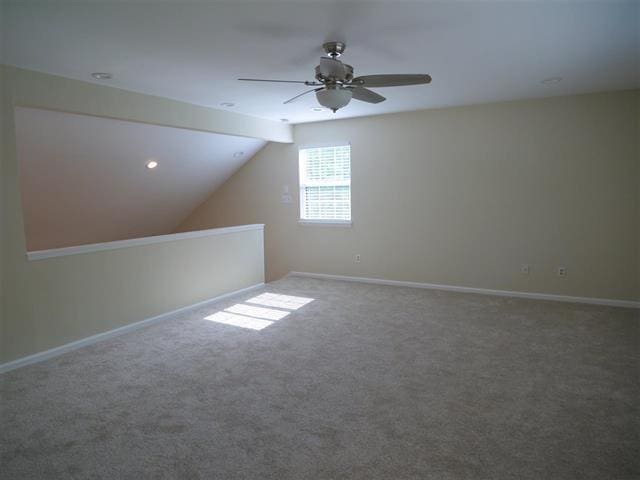 additional living space featuring carpet floors, ceiling fan, and lofted ceiling