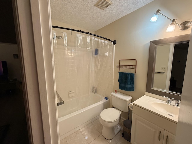 full bathroom featuring tile patterned floors, vanity, a textured ceiling, shower / tub combo with curtain, and toilet