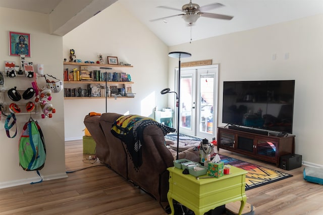 living room with ceiling fan, vaulted ceiling, and hardwood / wood-style flooring