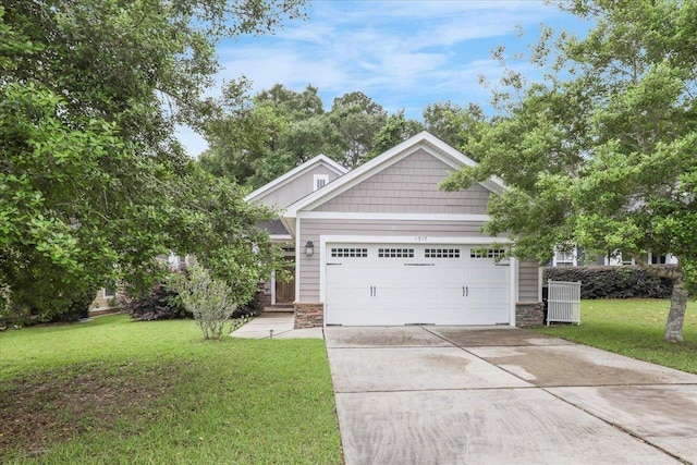 2542 Manassas Way, Tallahassee, FL 32312 - view of front of home featuring driveway, a garage, stone siding, and a front yard