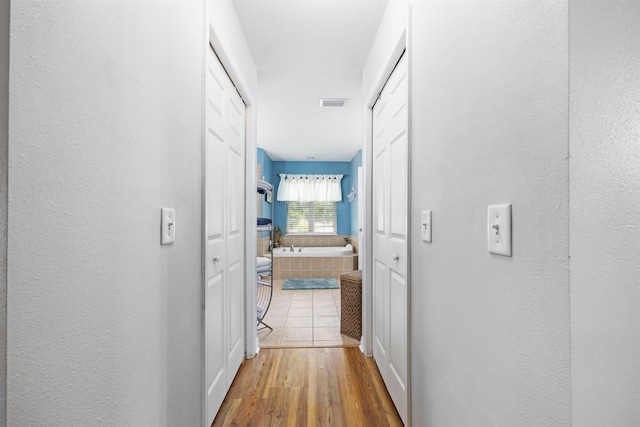 corridor featuring hardwood / wood-style floors