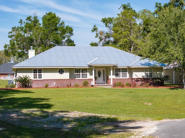 ranch-style home featuring cooling unit and a front yard