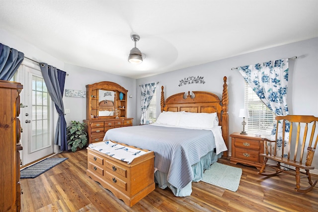 bedroom with dark hardwood / wood-style flooring and ceiling fan