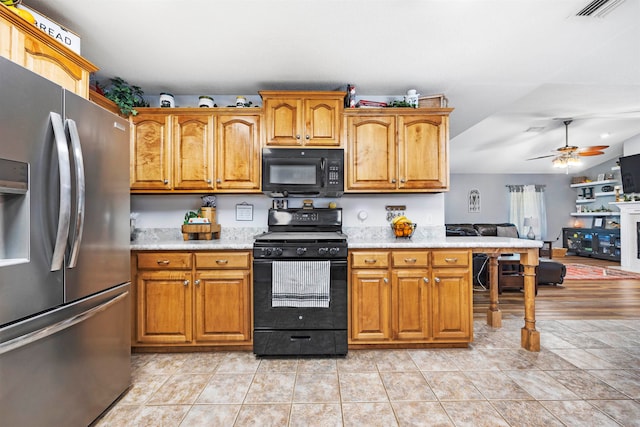 kitchen featuring light hardwood / wood-style floors, ceiling fan, and black appliances