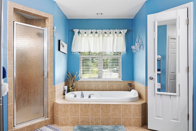 bathroom featuring shower with separate bathtub