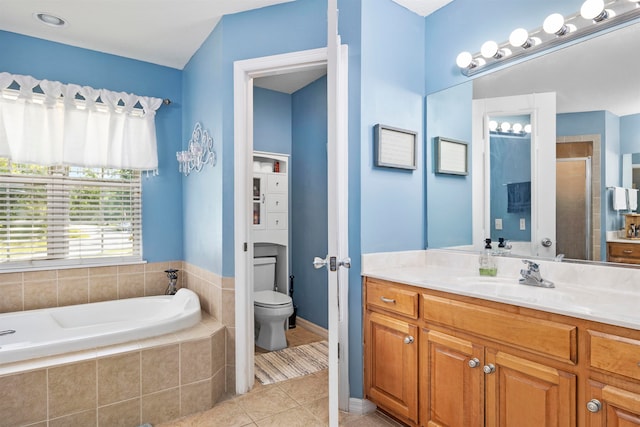 full bathroom featuring toilet, vanity, separate shower and tub, and tile patterned floors