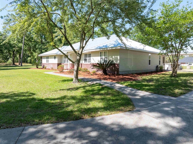 view of side of home with a yard