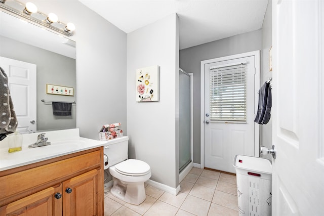 bathroom with vanity, a shower with shower door, tile patterned flooring, and toilet