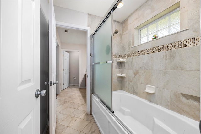 bathroom featuring combined bath / shower with glass door