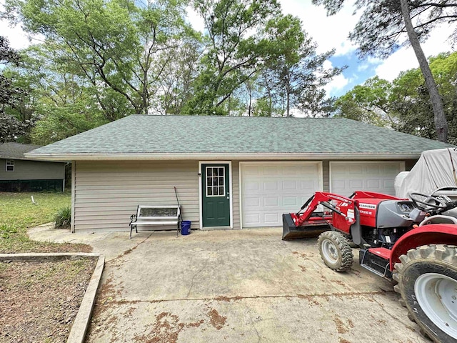 garage with concrete driveway