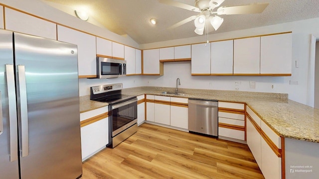 594 Green Oaks Rd, Havana, FL 32333 - kitchen with stainless steel appliances, light wood finished floors, white cabinetry, light countertops, and lofted ceiling