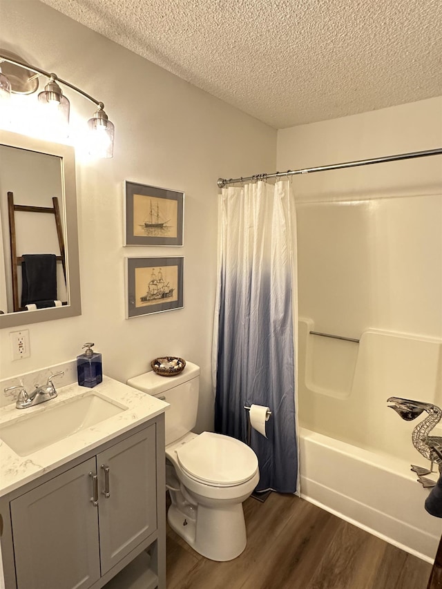 full bathroom with a textured ceiling, wood finished floors, toilet, vanity, and shower / bath combination with curtain