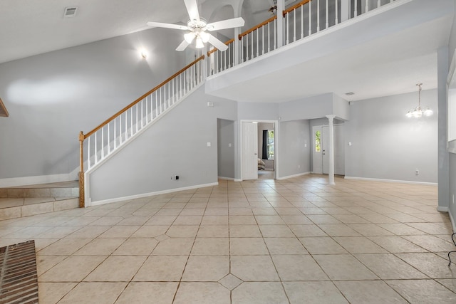 1520 Breamstone Rdg, Tallahassee, FL 32312 - unfurnished living room with a high ceiling, light tile patterned floors, ceiling fan, baseboards, and a chandelier