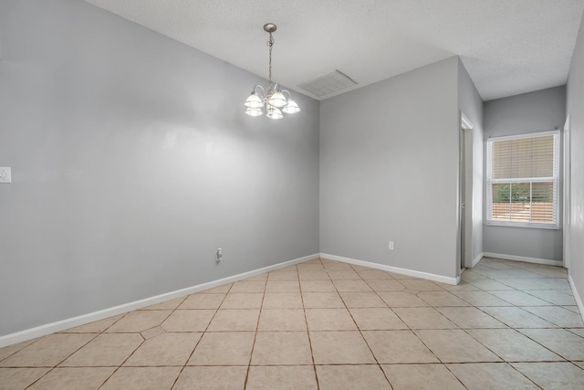 1520 Breamstone Rdg, Tallahassee, FL 32312 - spare room with a chandelier, light tile patterned floors, baseboards, and a textured ceiling
