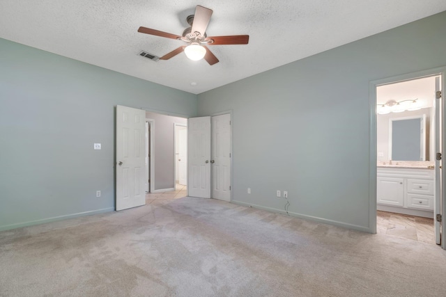 1520 Breamstone Rdg, Tallahassee, FL 32312 - unfurnished bedroom featuring light carpet, baseboards, connected bathroom, a textured ceiling, and a ceiling fan