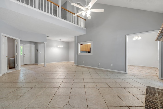 1520 Breamstone Rdg, Tallahassee, FL 32312 - unfurnished living room featuring a high ceiling, light tile patterned floors, a ceiling fan, a chandelier, and baseboards