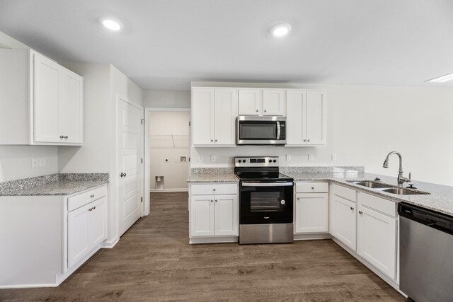 kitchen featuring dark hardwood / wood-style flooring, white cabinetry, sink, and stainless steel appliances