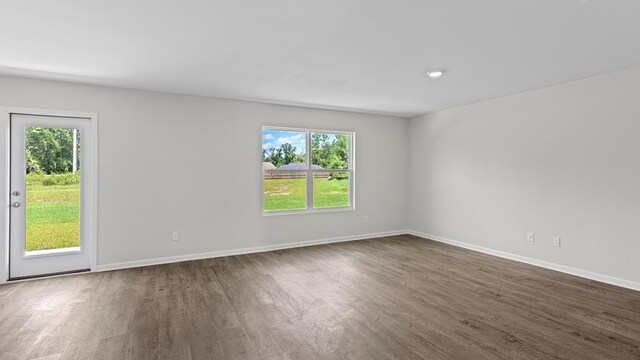 unfurnished room featuring dark hardwood / wood-style floors