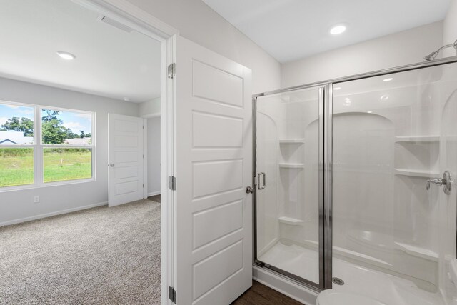 bathroom with a shower with door