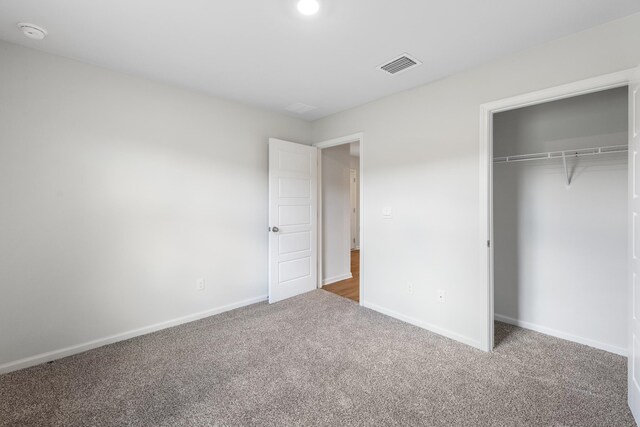 unfurnished bedroom featuring a closet and carpet floors