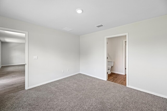 empty room with dark hardwood / wood-style flooring