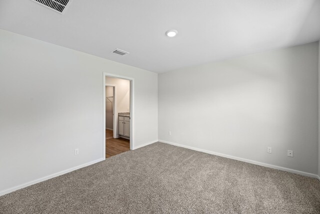 empty room with dark colored carpet